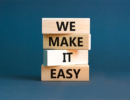 Wooden blocks spelling 'WE MAKE IT EASY