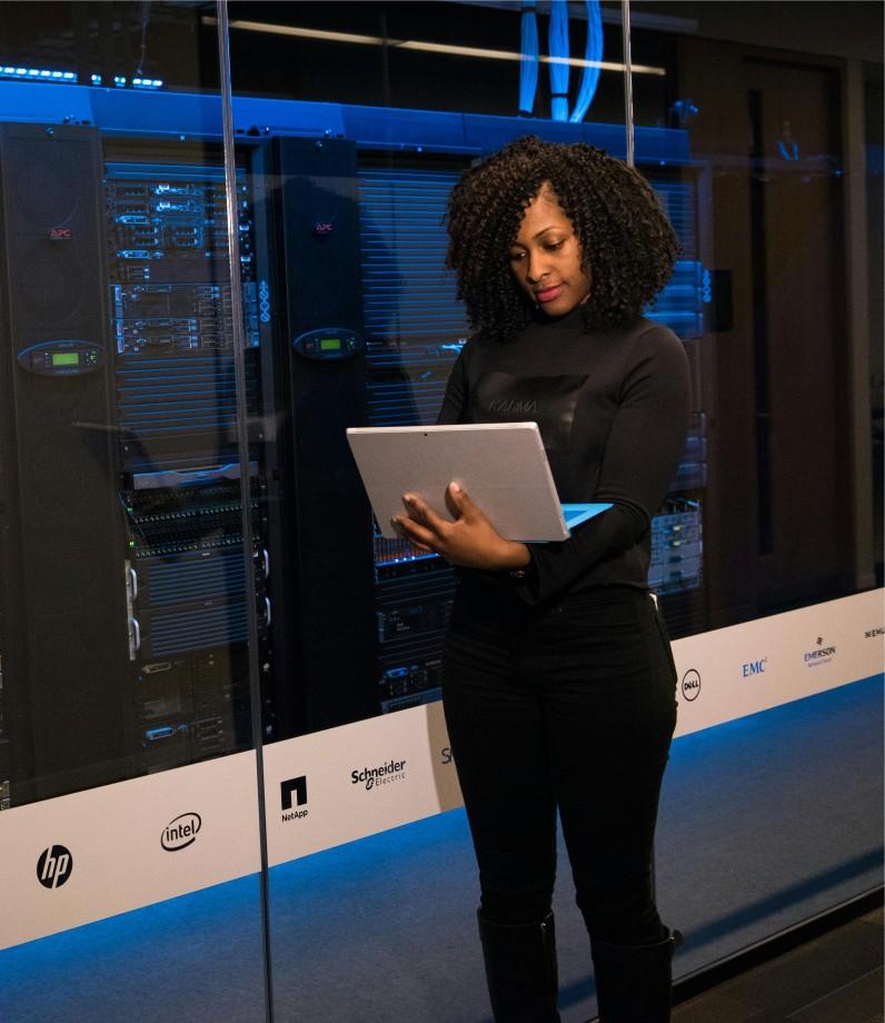 women standing with laptop - steelbrooktech